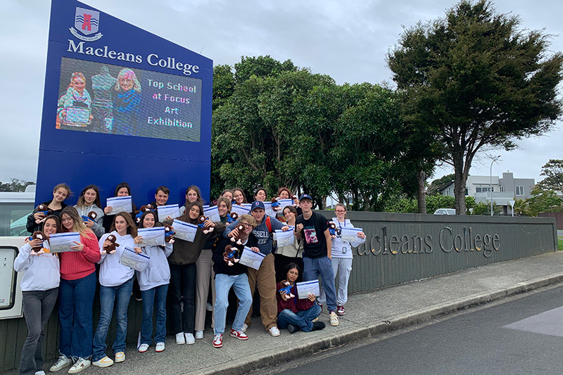 Macleans College international students from Italy celebrating their graduation at the school entrance
