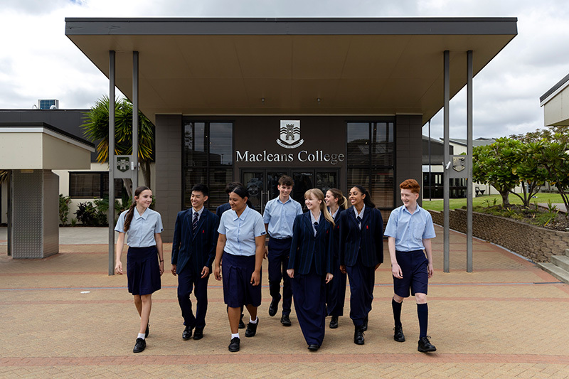 Macleans College students walking in front of the school entrance