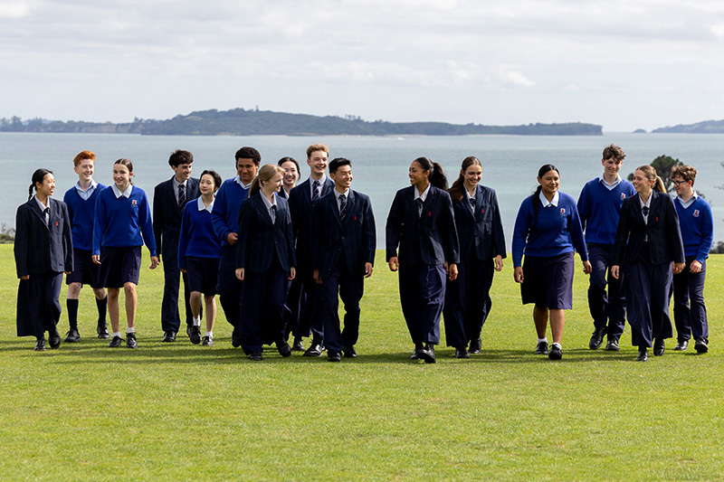 Macleans College students walking across school fields with sea views behind