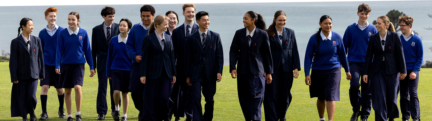 Macleans College students walking across school fields with sea views behind